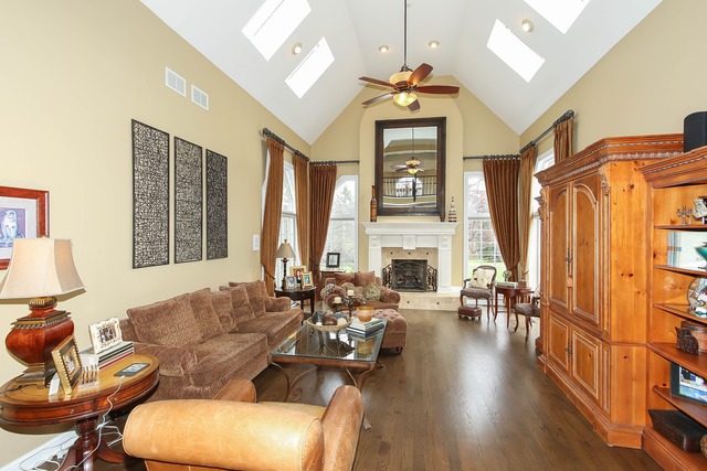 Undisclosed Address Long Grove, IL 60047 - Photo 12 of 25 a living room with furniture a fireplace and a large window
