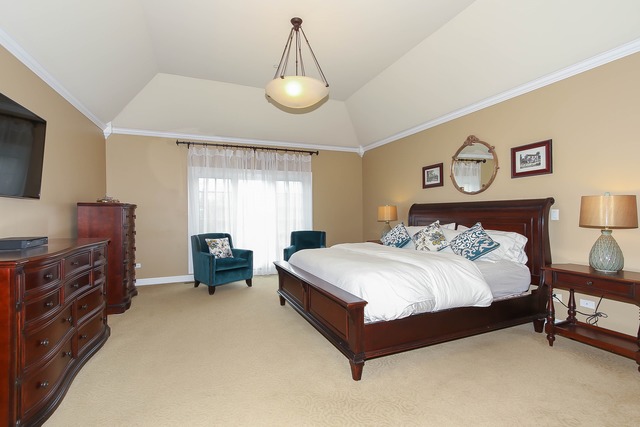 Undisclosed Address Long Grove, IL 60047 - Photo 14 of 25 a spacious bedroom with a bed and a flat tv screen on dresser