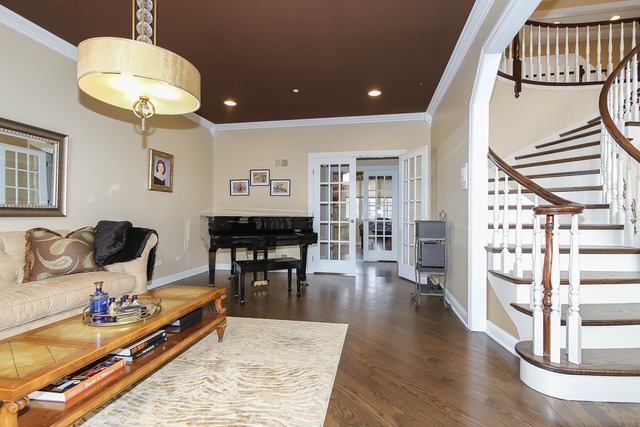 Undisclosed Address Long Grove, IL 60047 - Photo 5 of 25 a living room with furniture a piano and a chandelier