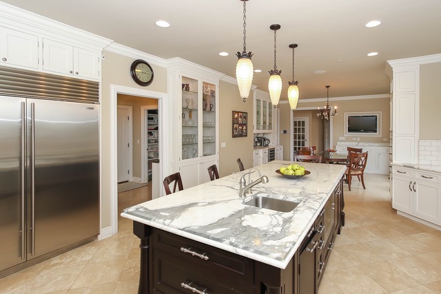Undisclosed Address Long Grove, IL 60047 - Photo 9 of 25 a kitchen with a table a refrigerator and a kitchen island