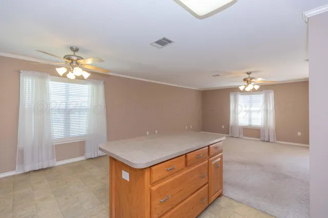 a room with ceiling fan and window