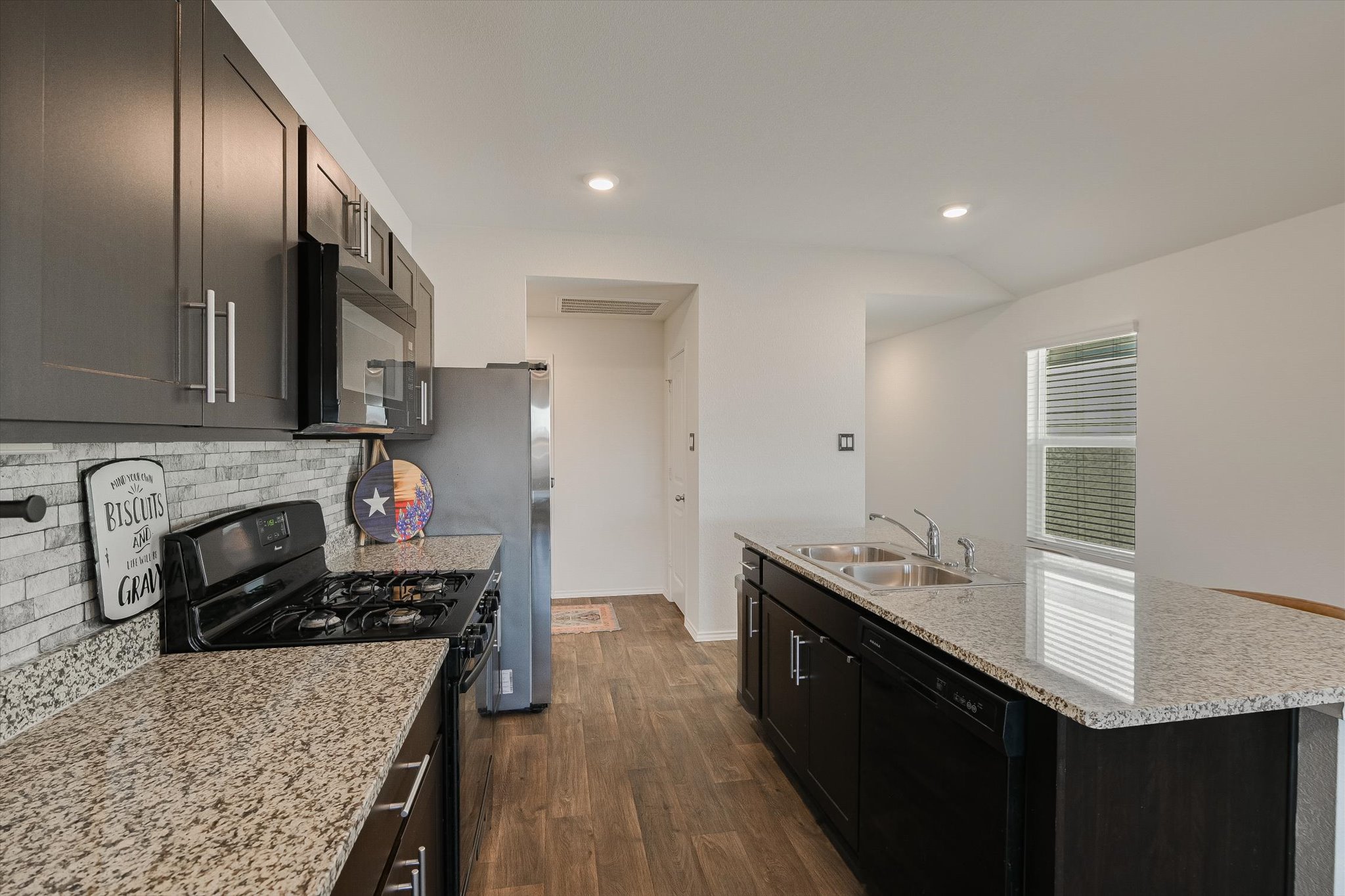 232 Euclid Lane Kyle, TX 78640 - Photo 6 of 15 a kitchen with stainless steel appliances granite countertop a sink stove and refrigerator