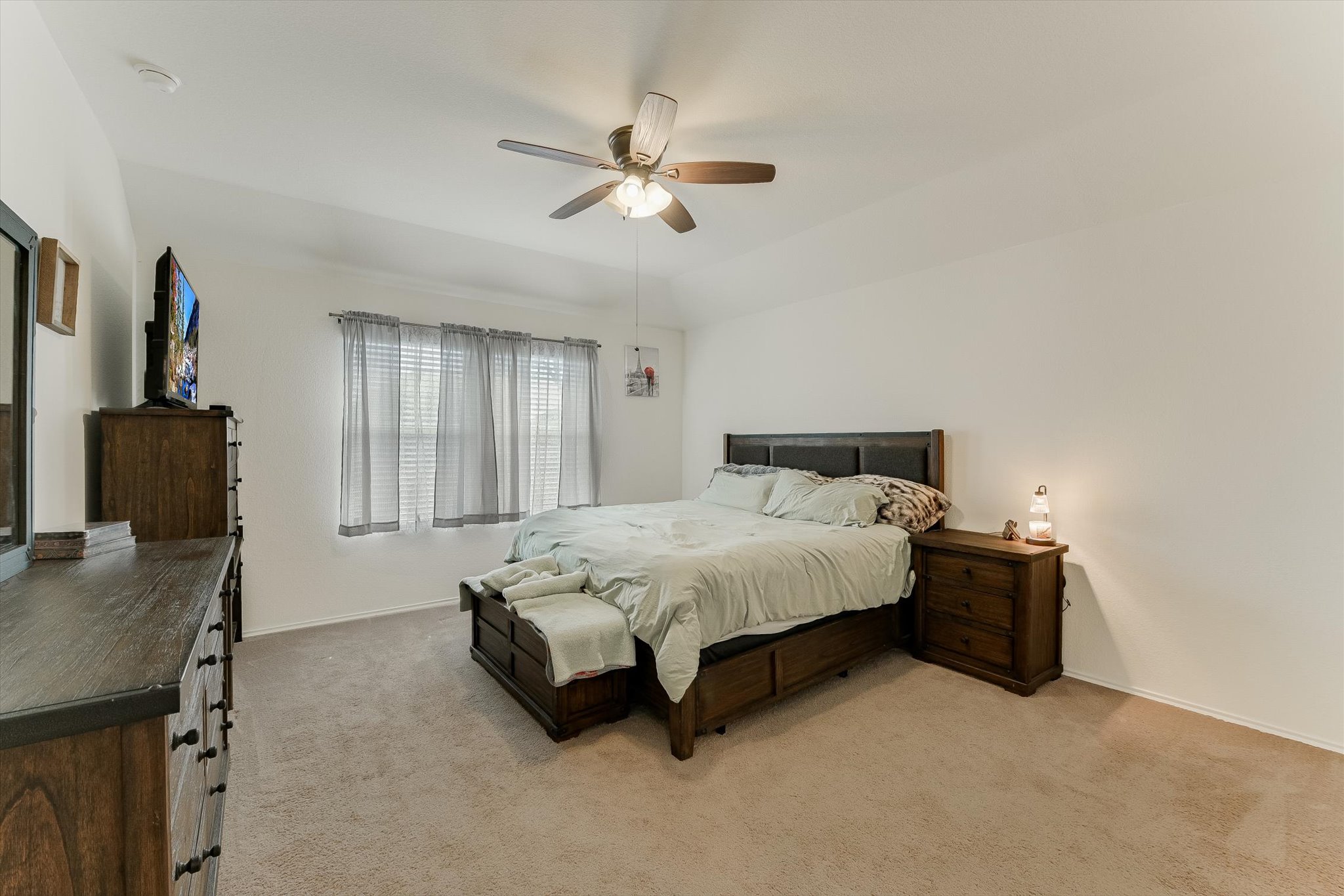232 Euclid Lane Kyle, TX 78640 - Photo 9 of 15 a spacious bedroom with a bed and a table