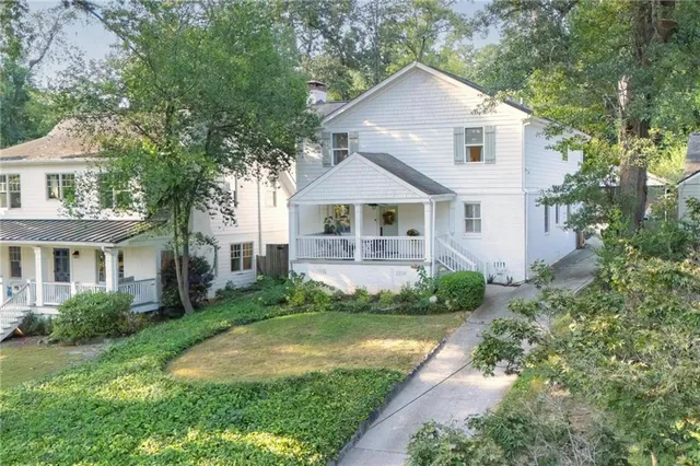 a front view of a house with a yard and porch