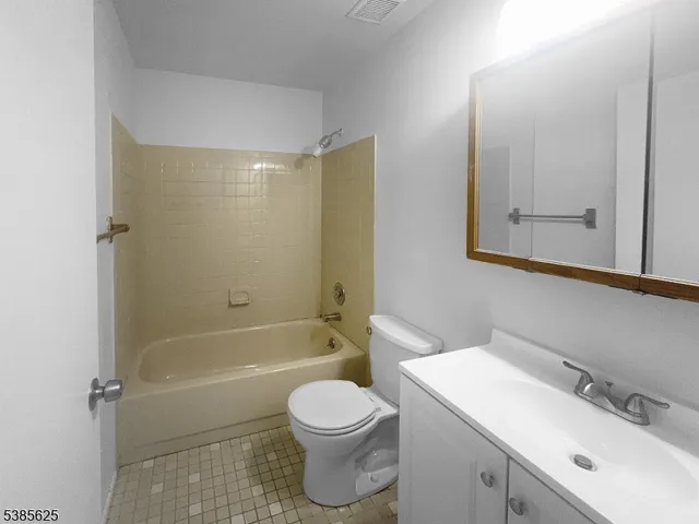 a bathroom with a sink toilet vanity and shower