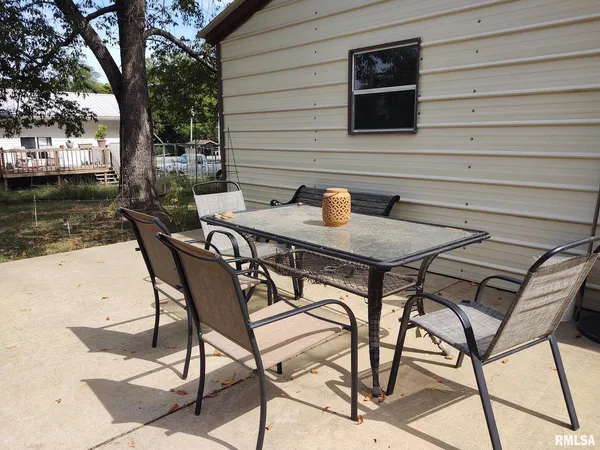 a backyard of a house with table and chairs