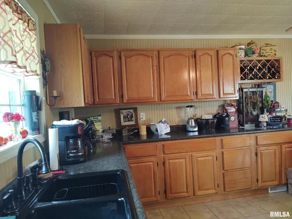 a kitchen with stainless steel appliances granite countertop a refrigerator and sink