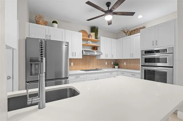 a kitchen with granite countertop a refrigerator and a sink