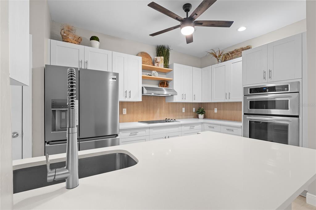 4221 West Spruce Street, Unit 1108 Tampa, FL 33607 - Photo 11 of 31 a kitchen with granite countertop a refrigerator and a sink