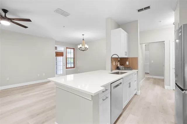 a kitchen with a sink stove and refrigerator