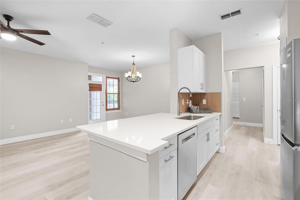 4221 West Spruce Street, Unit 1108 Tampa, FL 33607 - Photo 12 of 31 a kitchen with a sink stove and refrigerator