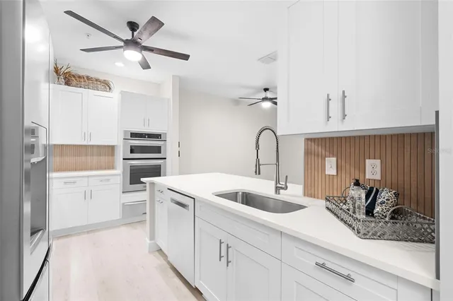 a kitchen with a sink and a refrigerator