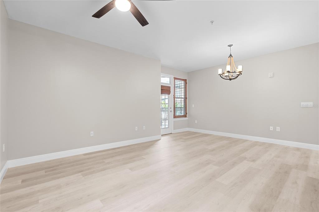4221 West Spruce Street, Unit 1108 Tampa, FL 33607 - Photo 17 of 31 an empty room with chandelier fan and windows