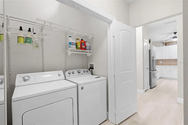 a view of washer and dryer with white walls