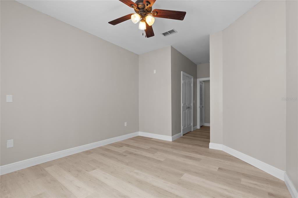 4221 West Spruce Street, Unit 1108 Tampa, FL 33607 - Photo 21 of 31 an empty room with closet and a chandelier fan