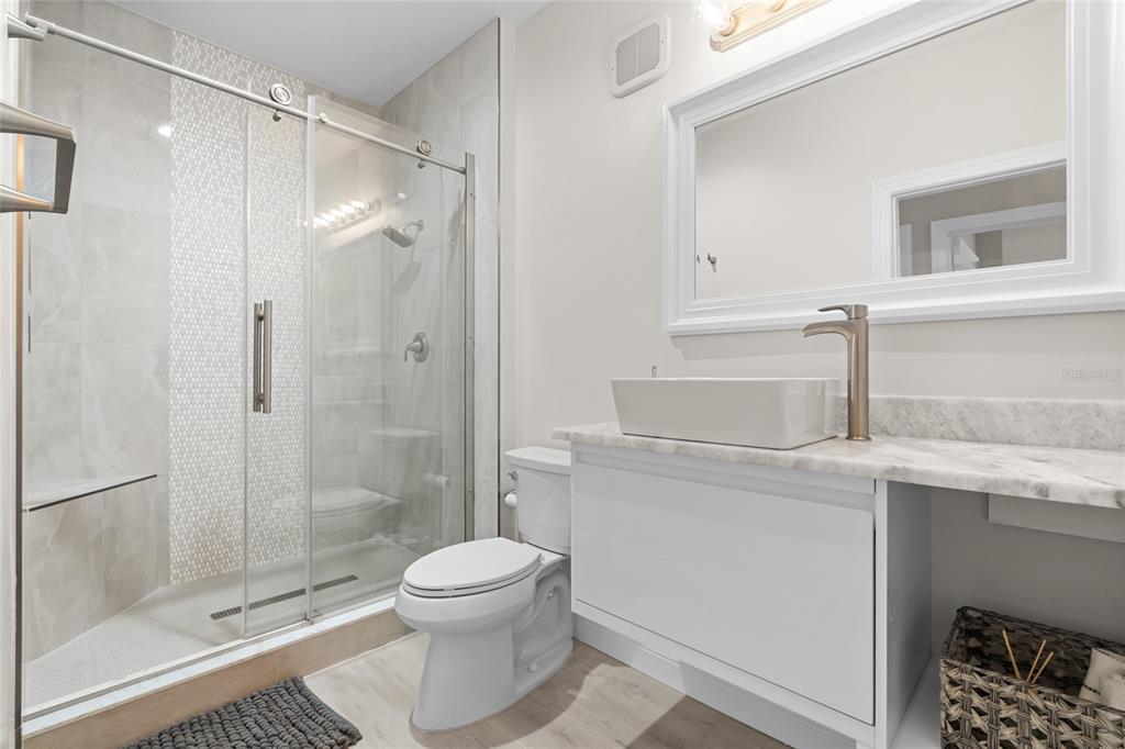 4221 West Spruce Street, Unit 1108 Tampa, FL 33607 - Photo 24 of 31 a bathroom with a shower a sink and toilet