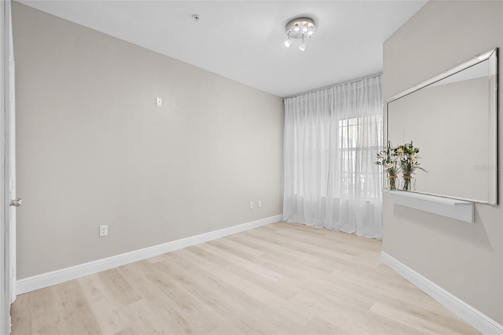 4221 West Spruce Street, Unit 1108 Tampa, FL 33607 - Photo 25 of 31 wooden floor in an empty room with a window