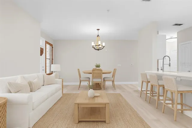 a dining room with furniture and a chandelier