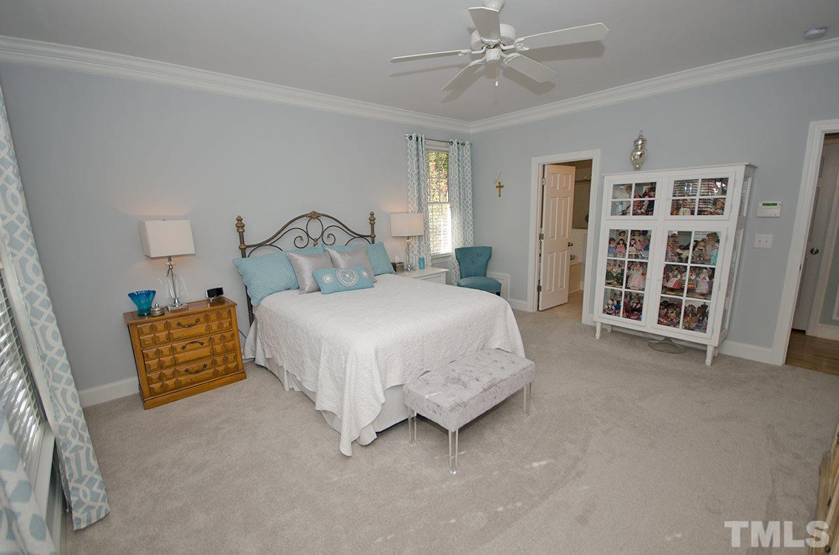1106 Stanridge Drive Raleigh, NC 27613 - Photo 14 of 24 a spacious bedroom with a bed and a walk in closet