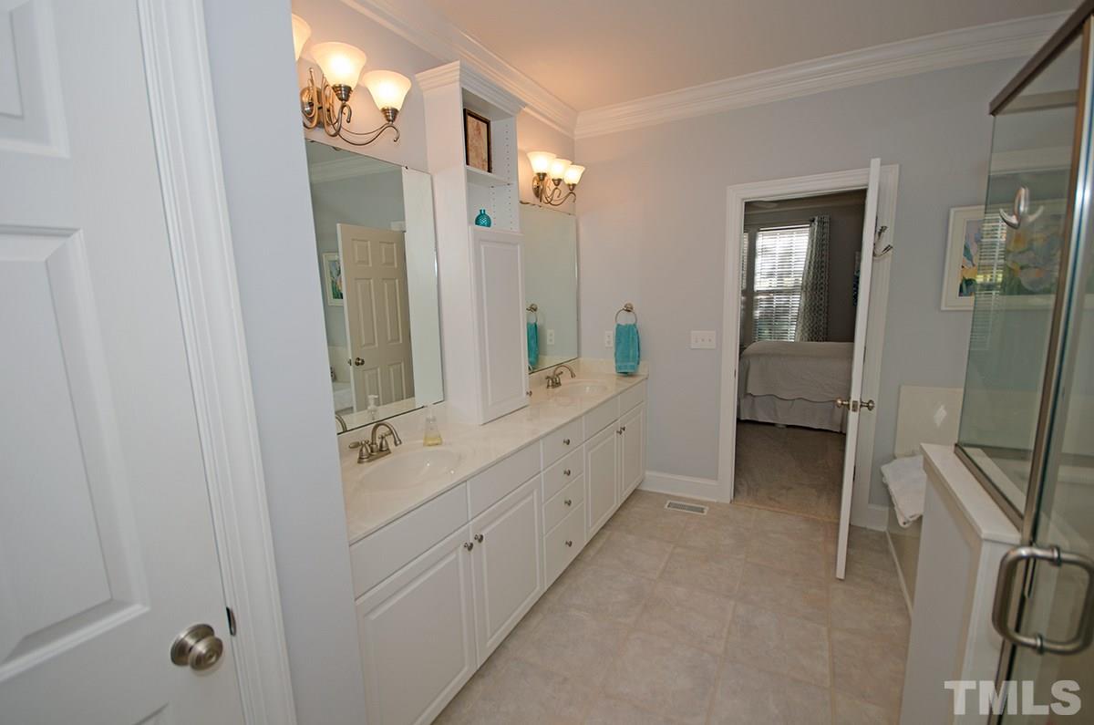 1106 Stanridge Drive Raleigh, NC 27613 - Photo 15 of 24 a spacious bathroom with a double vanity sink a mirror and shower