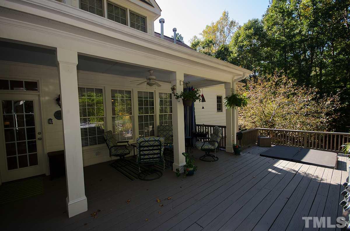 1106 Stanridge Drive Raleigh, NC 27613 - Photo 20 of 24 a view of a patio with table and chairs and wooden floor
