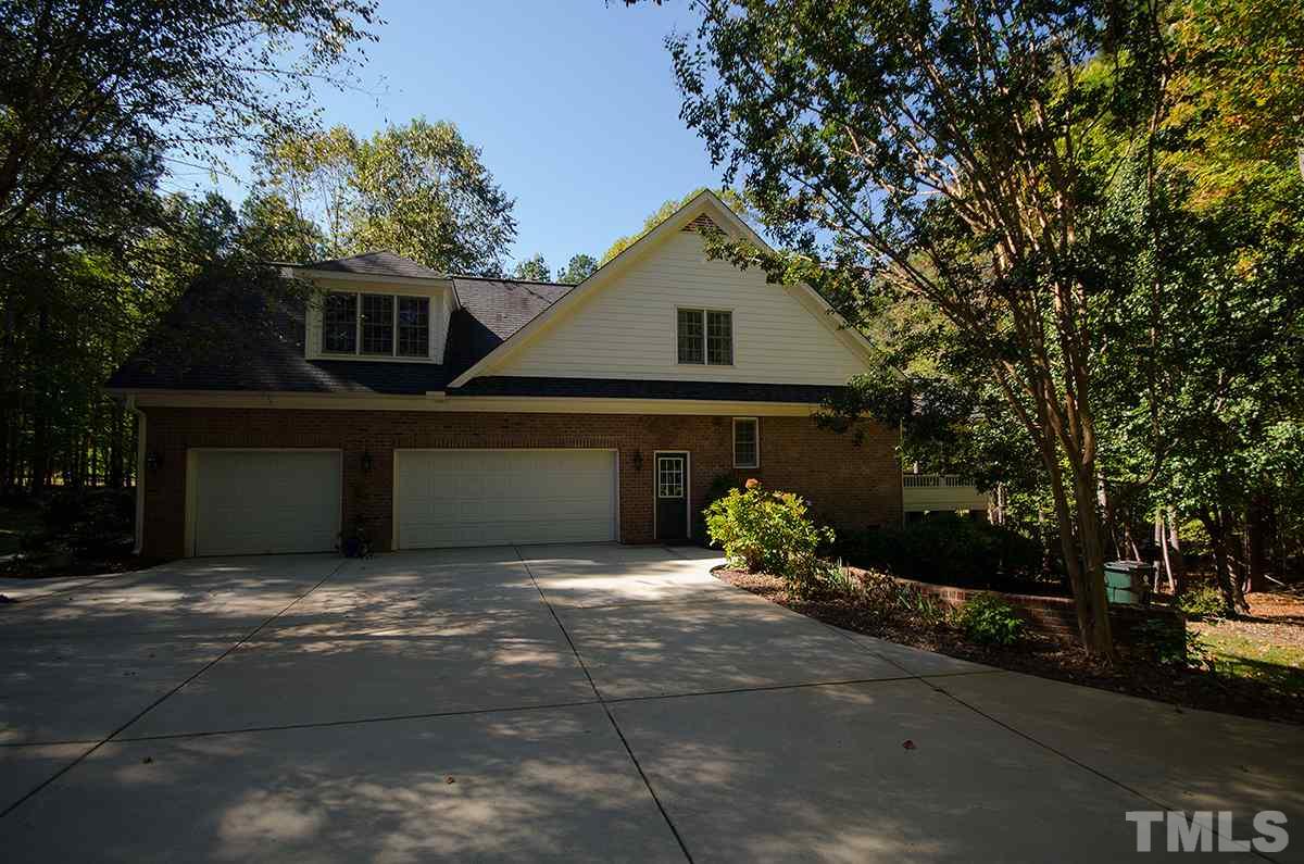 1106 Stanridge Drive Raleigh, NC 27613 - Photo 22 of 24 a front view of a house with a yard and garage