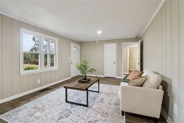 a view of a livingroom with a window and flower chair