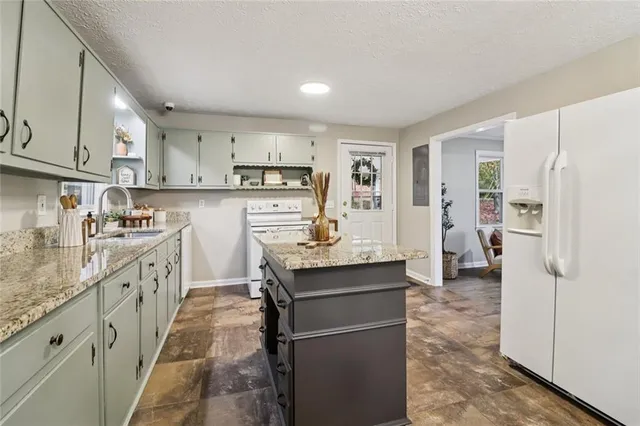 a kitchen with refrigerator cabinets and wooden floor