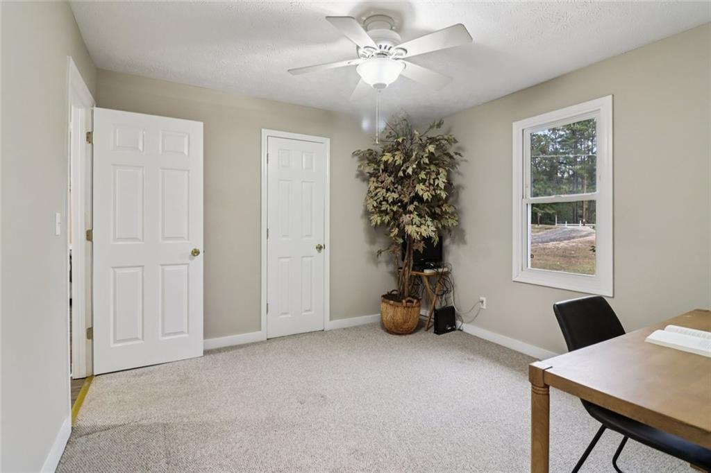 8969 Highway 166 Winston, GA 30187 - Photo 23 of 63 a view of a livingroom with a window and flower chair