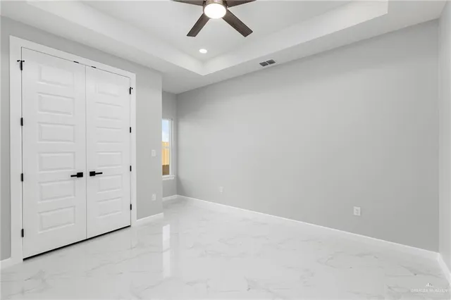 an empty room with a ceiling fan