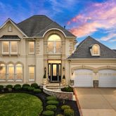 an aerial view of a house with a big yard