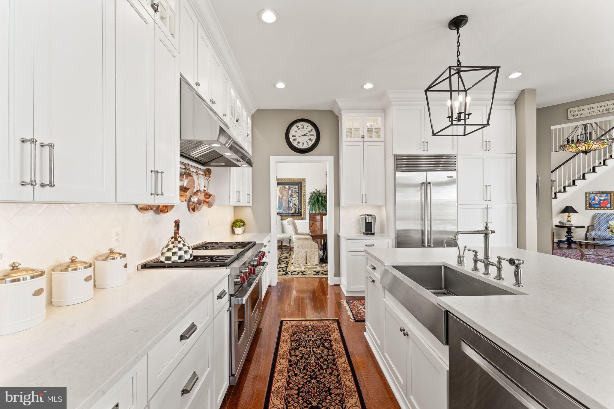 43524 Jackson Hole Circle Leesburg, VA 20176 - Photo 12 of 149 a kitchen with stainless steel appliances a sink a stove and a wooden floors