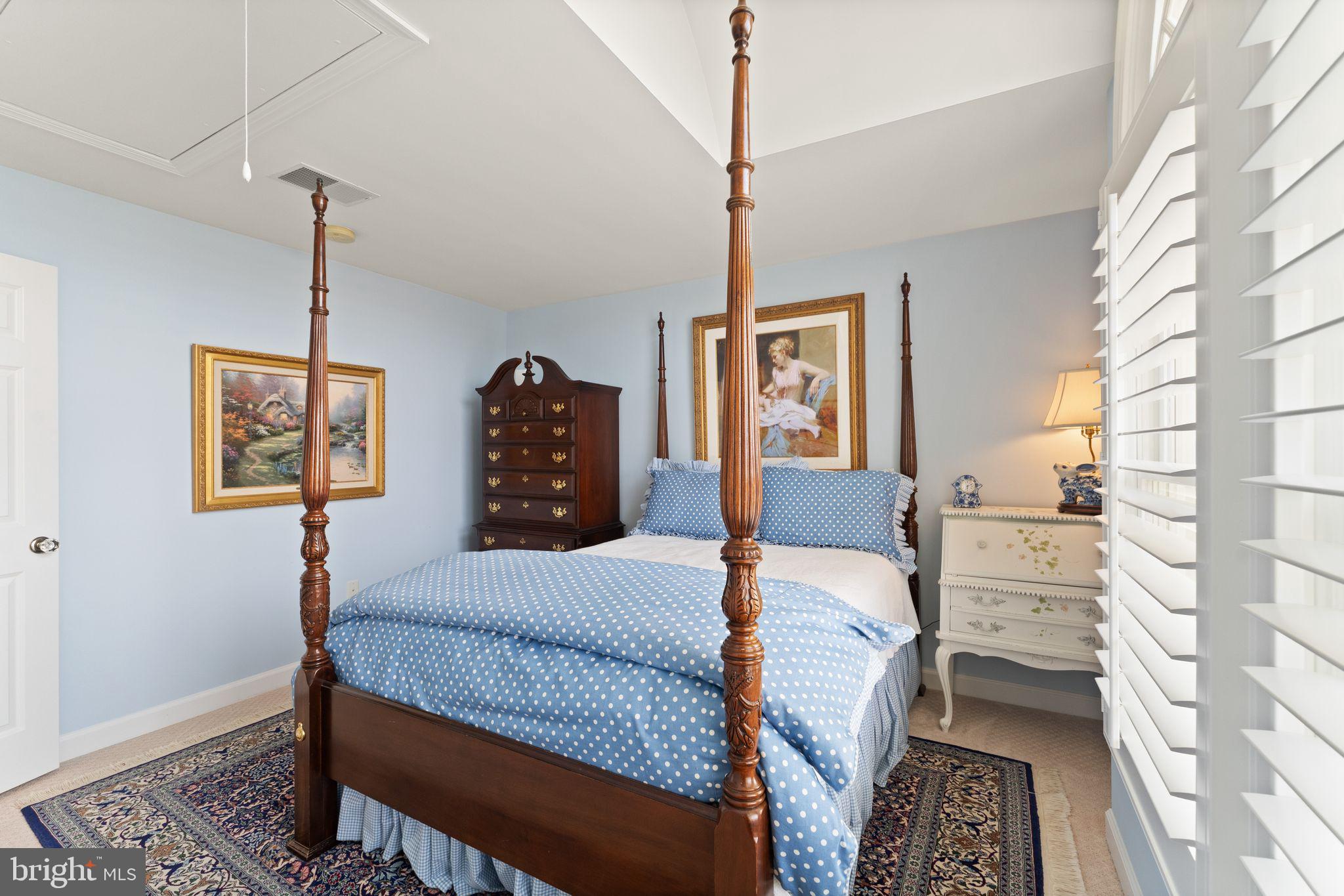 43524 Jackson Hole Circle Leesburg, VA 20176 - Photo 60 of 149 a bedroom with a bed and a chandelier