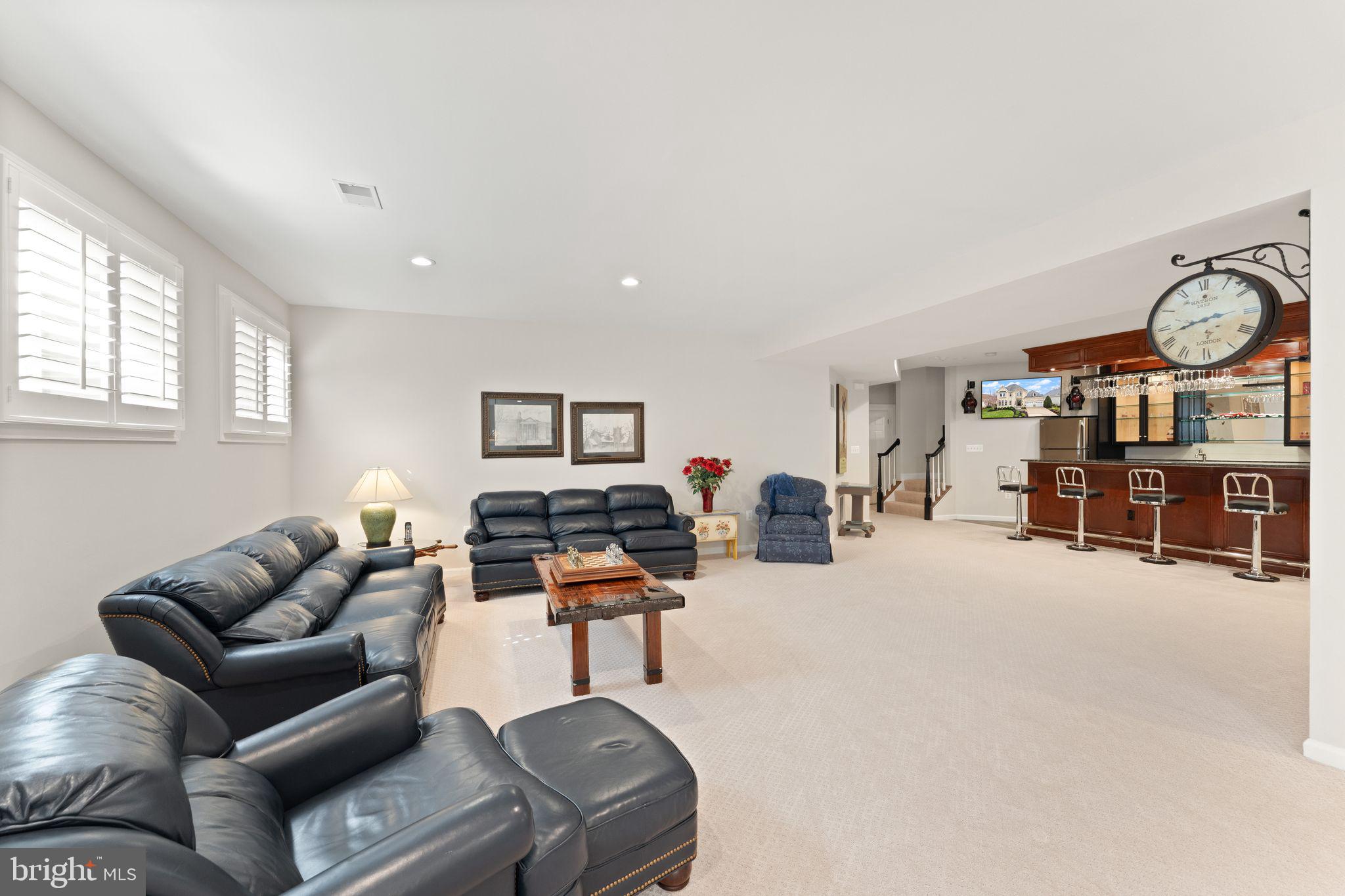 43524 Jackson Hole Circle Leesburg, VA 20176 - Photo 66 of 149 a living room with furniture a flat screen tv and a large window