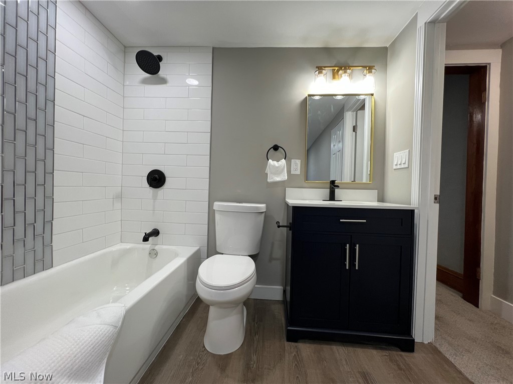 4523 Maplecrest Avenue Parma, OH 44134 - Photo 26 of 31 Full bathroom with toilet, tiled shower / bath, vanity, and hardwood / wood-style flooring