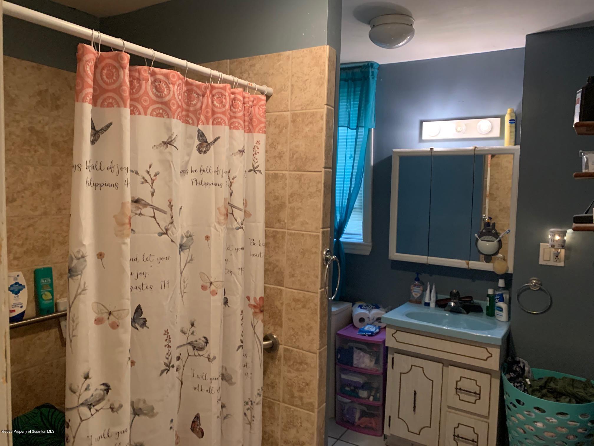228 North Main Street Taylor, PA 18517 - Photo 3 of 15 a bathroom with a sink and a mirror