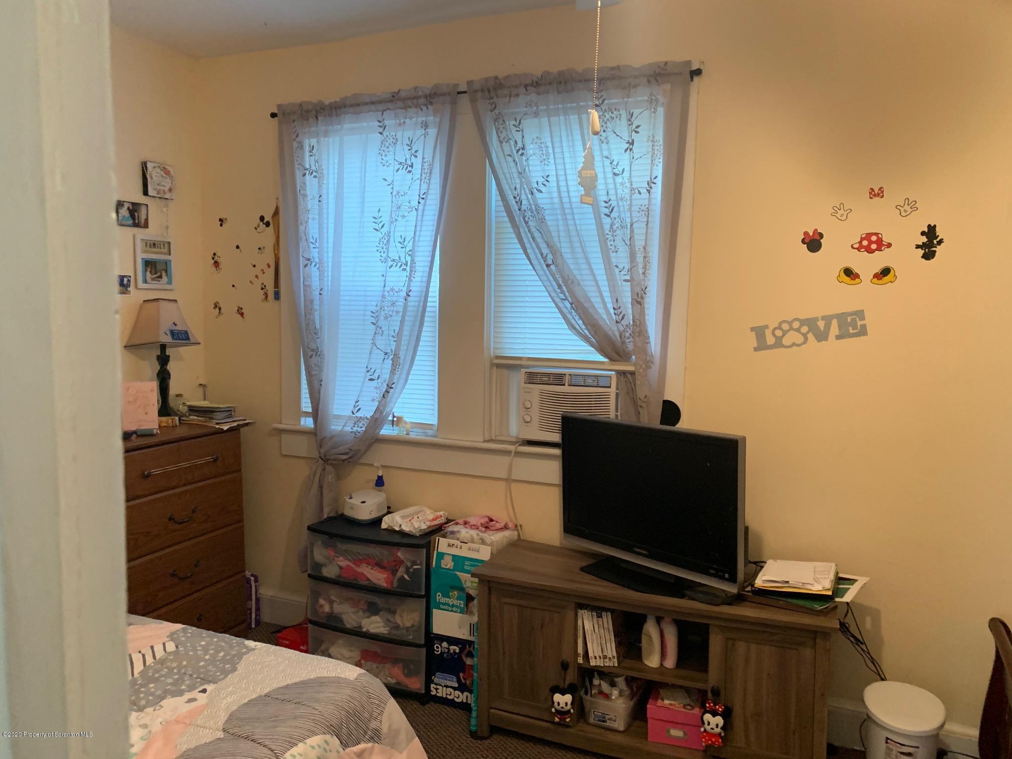 228 North Main Street Taylor, PA 18517 - Photo 6 of 15 a bedroom with a bed and furniture