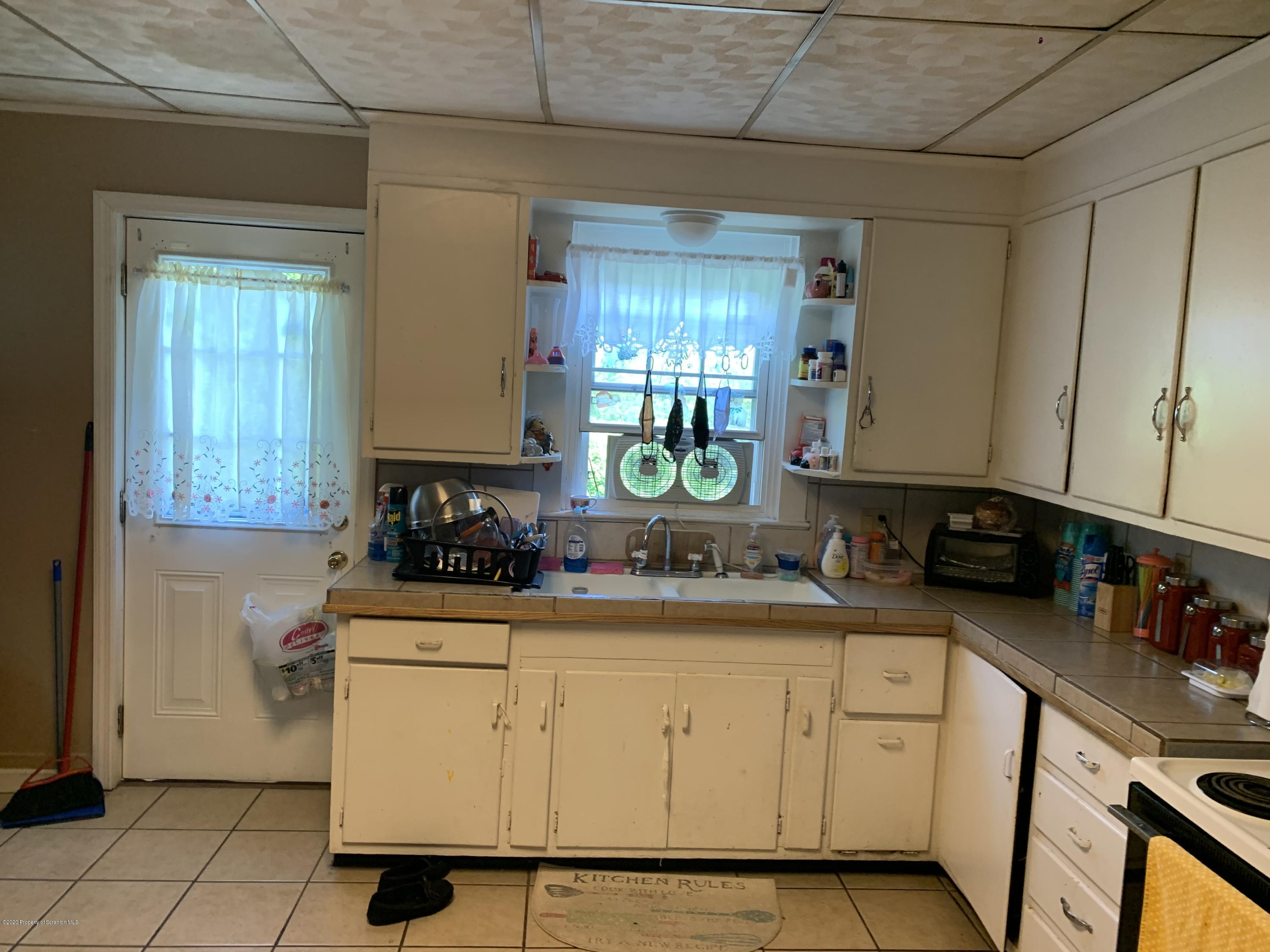 228 North Main Street Taylor, PA 18517 - Photo 9 of 15 a kitchen with sink cabinets and window