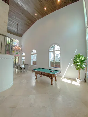 a living room with furniture a window and gym equipment