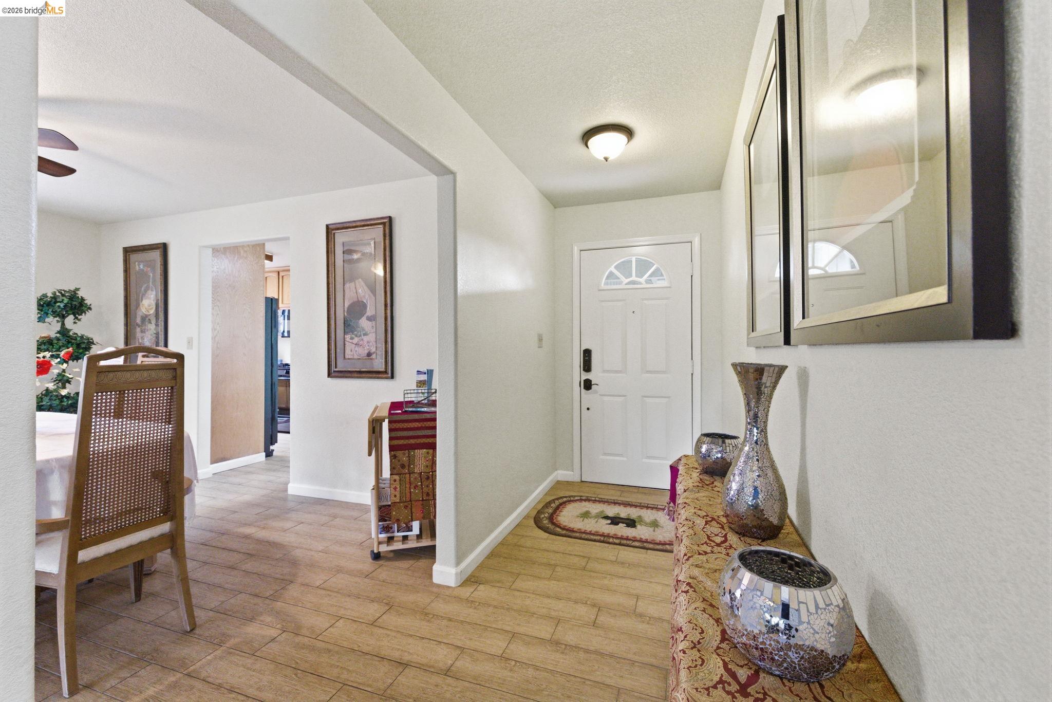 12068 Breckenridge Road Groveland, CA 95321 - Photo 15 of 55 Entryway featuring light wood-style flooring, ceiling fan, and a textured ceiling
