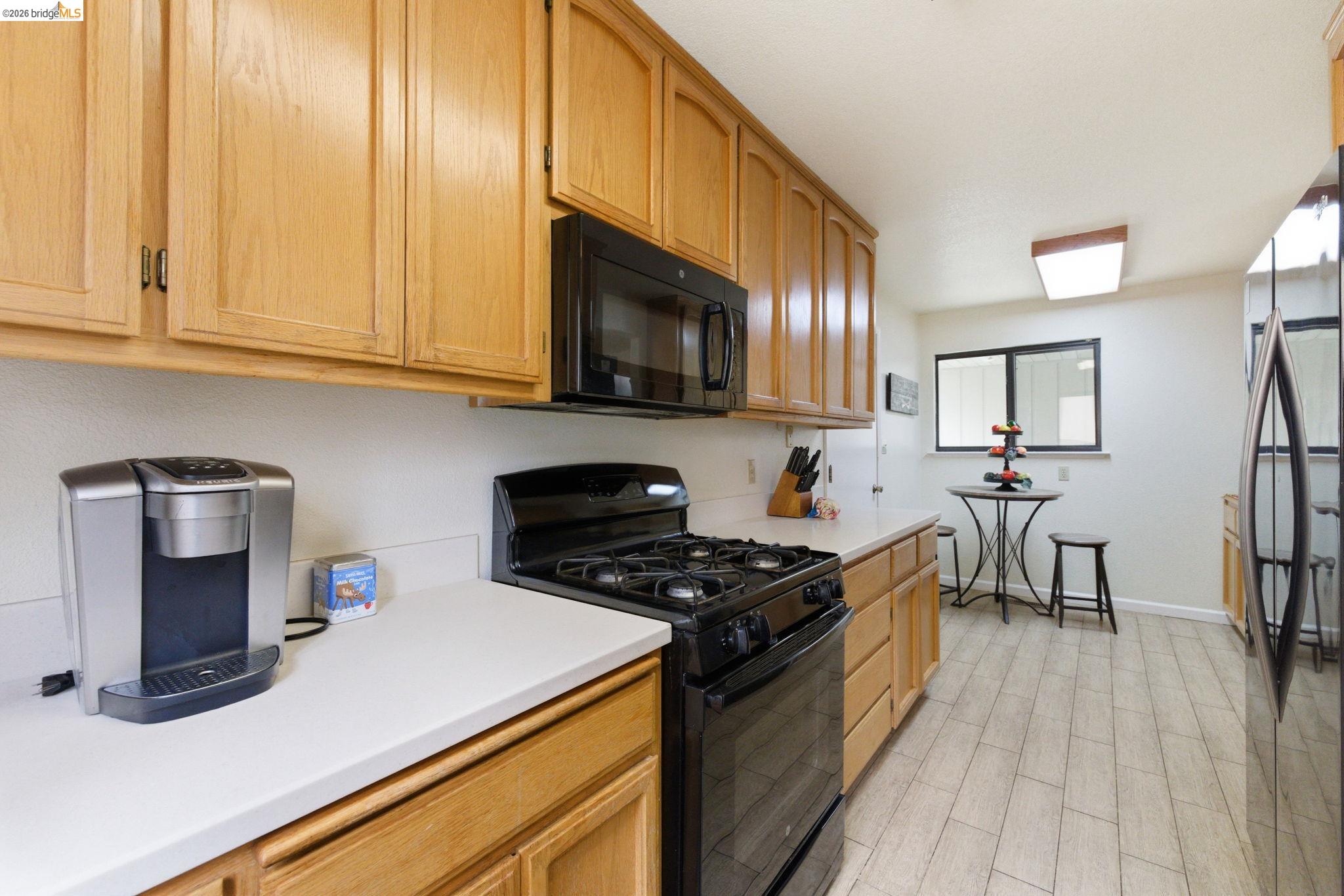 12068 Breckenridge Road Groveland, CA 95321 - Photo 20 of 55 a kitchen with stainless steel appliances a stove a sink a microwave and cabinets