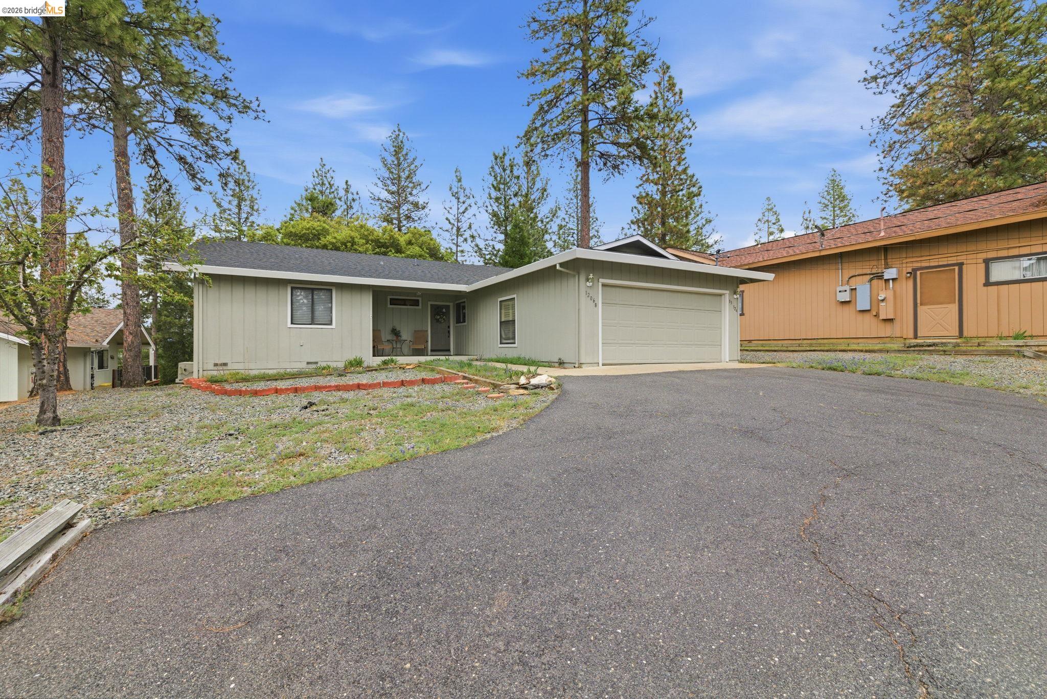 12068 Breckenridge Road Groveland, CA 95321 - Photo 29 of 55 Ranch-style house with a garage, driveway, a porch, and a shingled roof