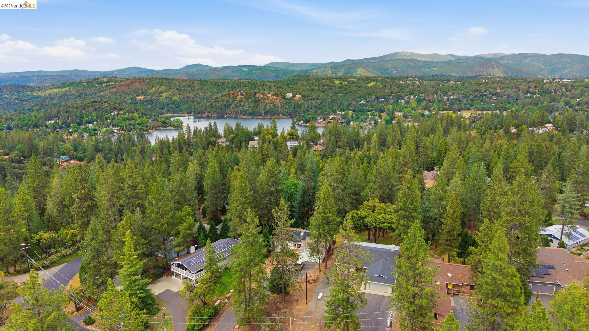 12068 Breckenridge Road Groveland, CA 95321 - Photo 36 of 55 Aerial view of a forest and a water and mountain view