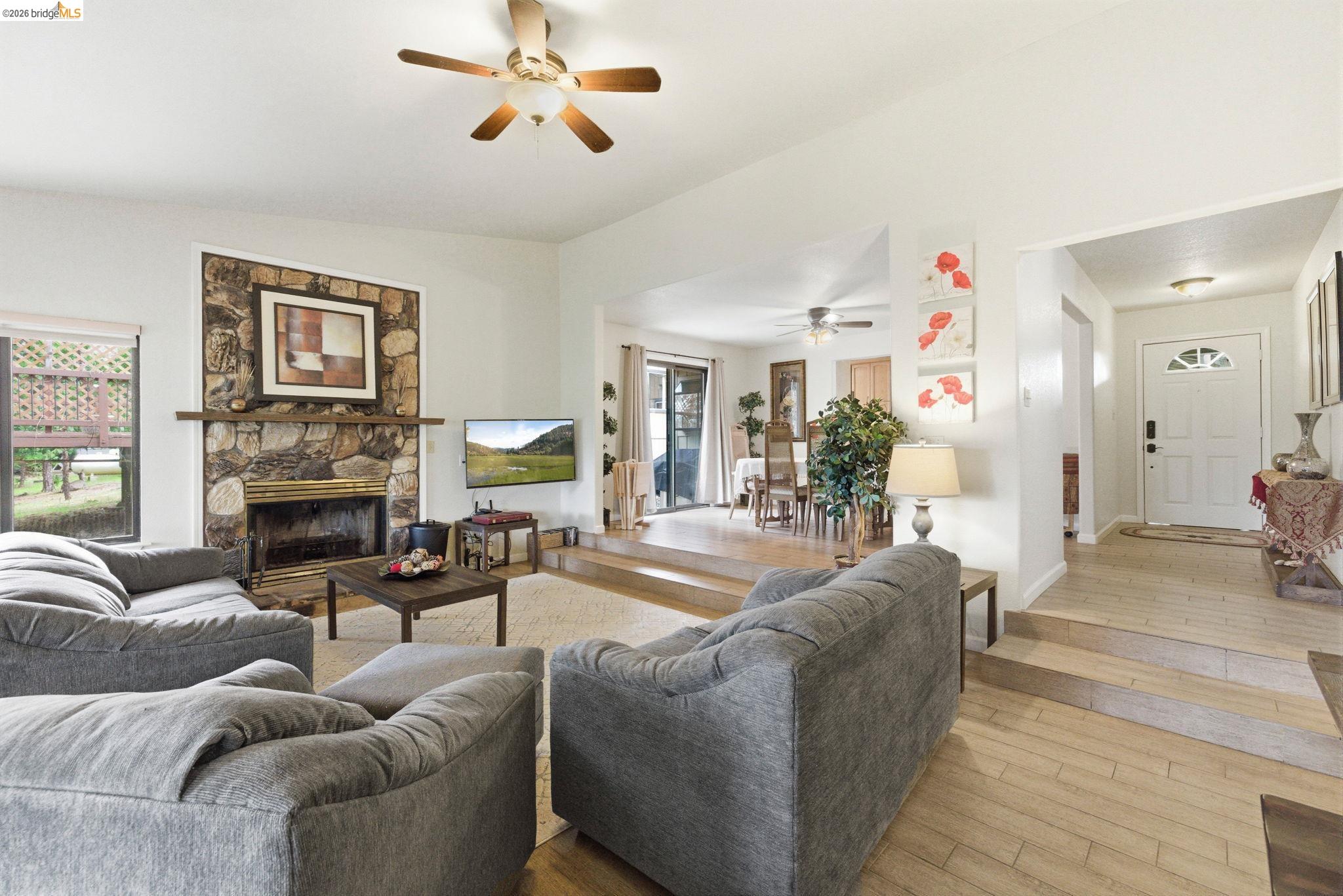 12068 Breckenridge Road Groveland, CA 95321 - Photo 9 of 55 Living area featuring hardwood / wood-style floors, a fireplace, and ceiling fan