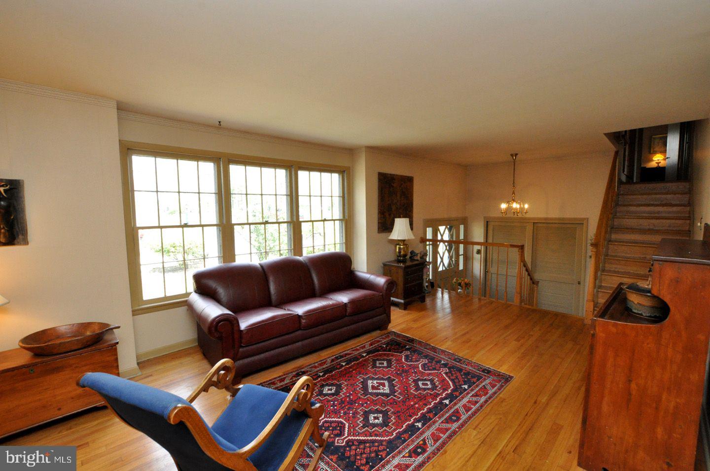 208 Ridge Road Southampton, NJ 08088 - Photo 11 of 34 a living room with furniture and a floor to ceiling window