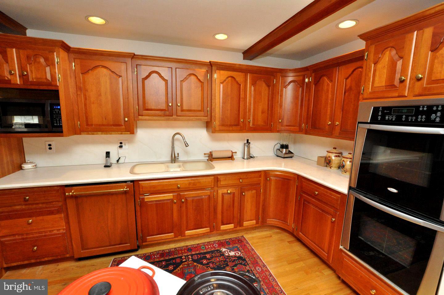 208 Ridge Road Southampton, NJ 08088 - Photo 16 of 34 a kitchen with stainless steel appliances granite countertop a sink dishwasher stove top oven and cabinets with wooden floor