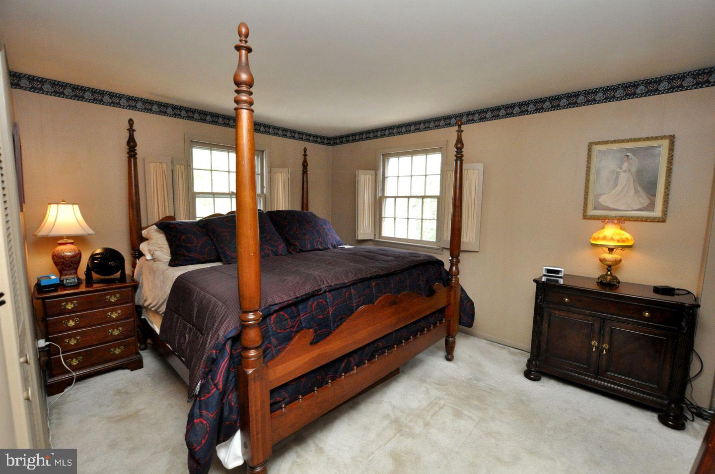 208 Ridge Road Southampton, NJ 08088 - Photo 21 of 34 a bedroom with a bed and a mirror on the dresser