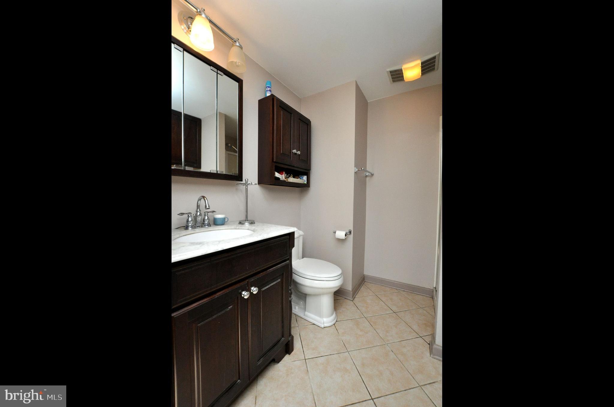 208 Ridge Road Southampton, NJ 08088 - Photo 27 of 34 a bathroom with a toilet a sink and mirror