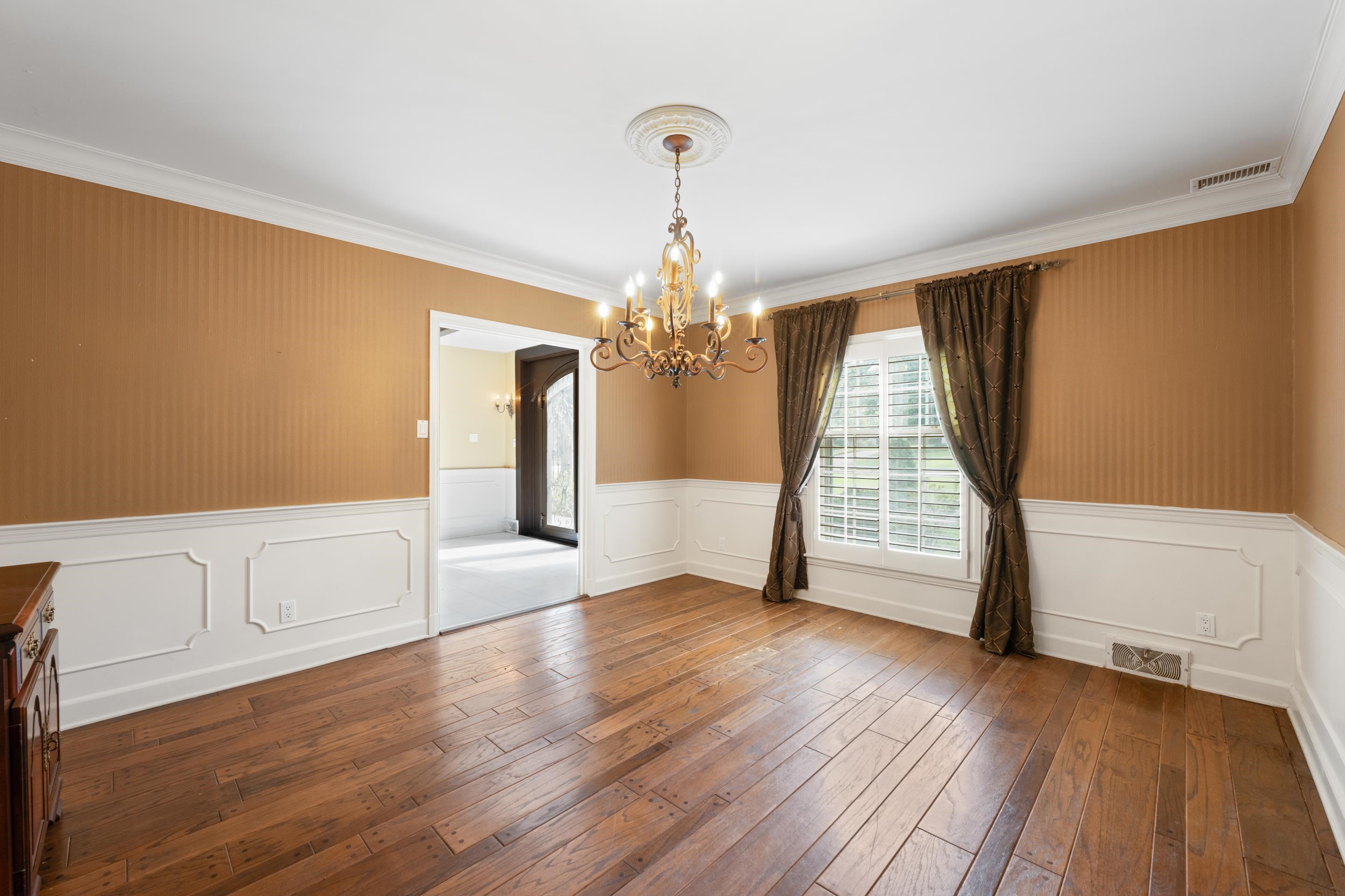 5360 Normandy Road Memphis, TN 38120 - Photo 18 of 40 Pegged hardwood floors and modern chandelier