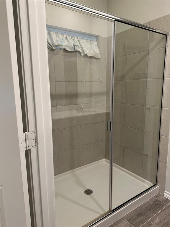 1613 Abbottsford Avenue Providence Village, TX 76227 - Photo 12 of 14 a bathroom with a glass shower door